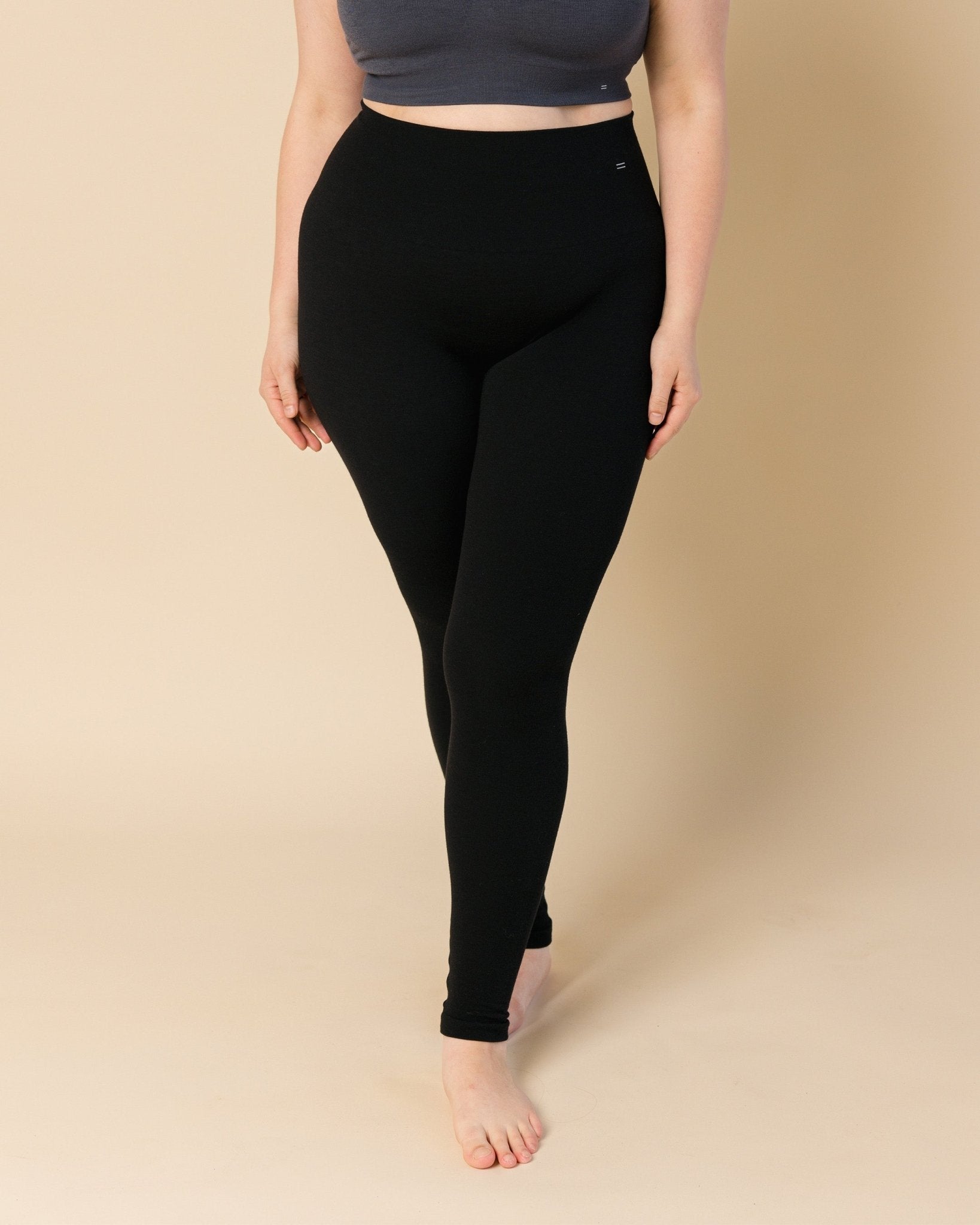 Woman wearing black Merino wool tights, the best leggings and baselayer.