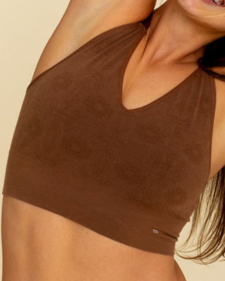 Woman stretching in BRANWYN Busty Bra in Dark Nude, Merino wool bralette with natural moisture-wicking fibers.