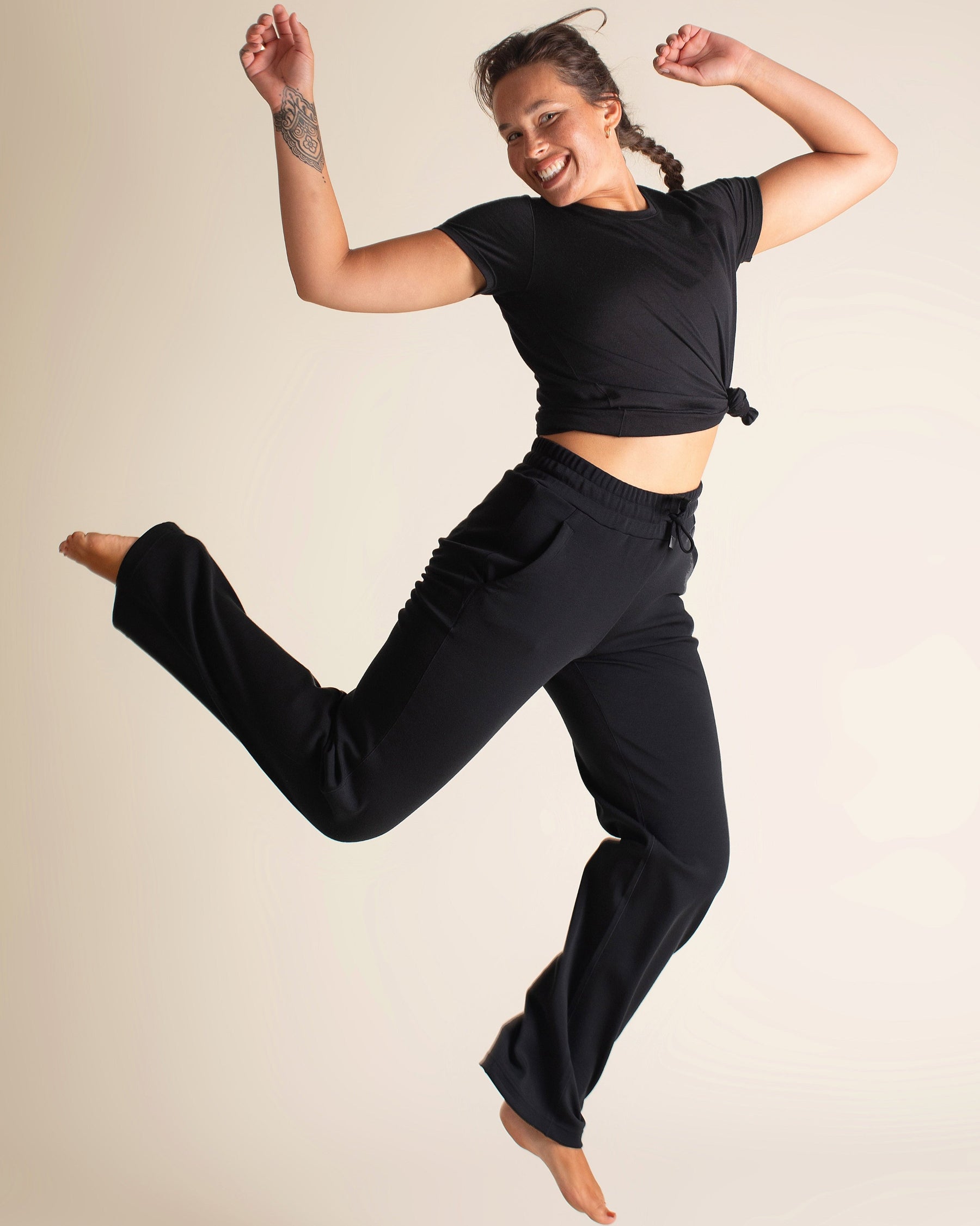 Woman wearing BRANWYN Women's Merino Wool Black Short Sleeve Tee and Women's Black Merino Wool Wide-Leg Pant