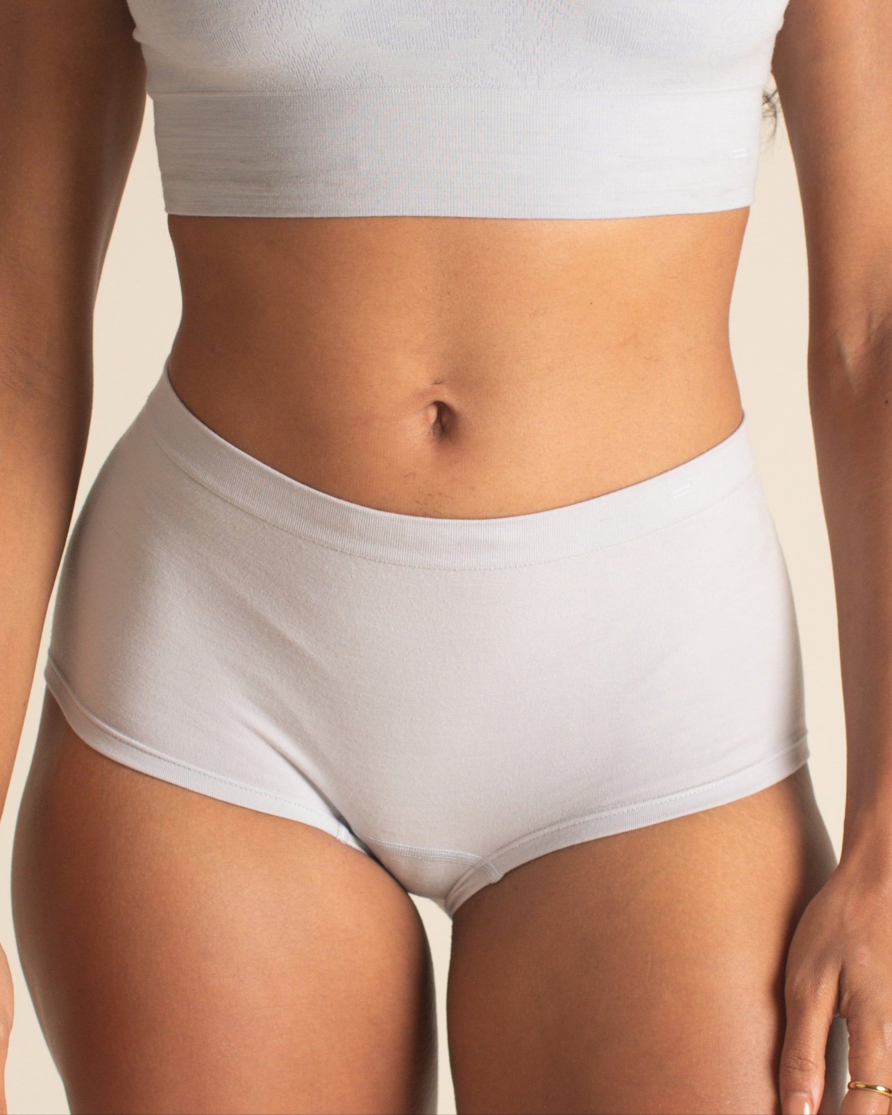 woman wearing BRAWNYN women's seamless Merino wool Boyshorts underwear and Busty Bra in Luna Gray. Great for skiing, winter sports, swimming, best hiking underwear, and travel.