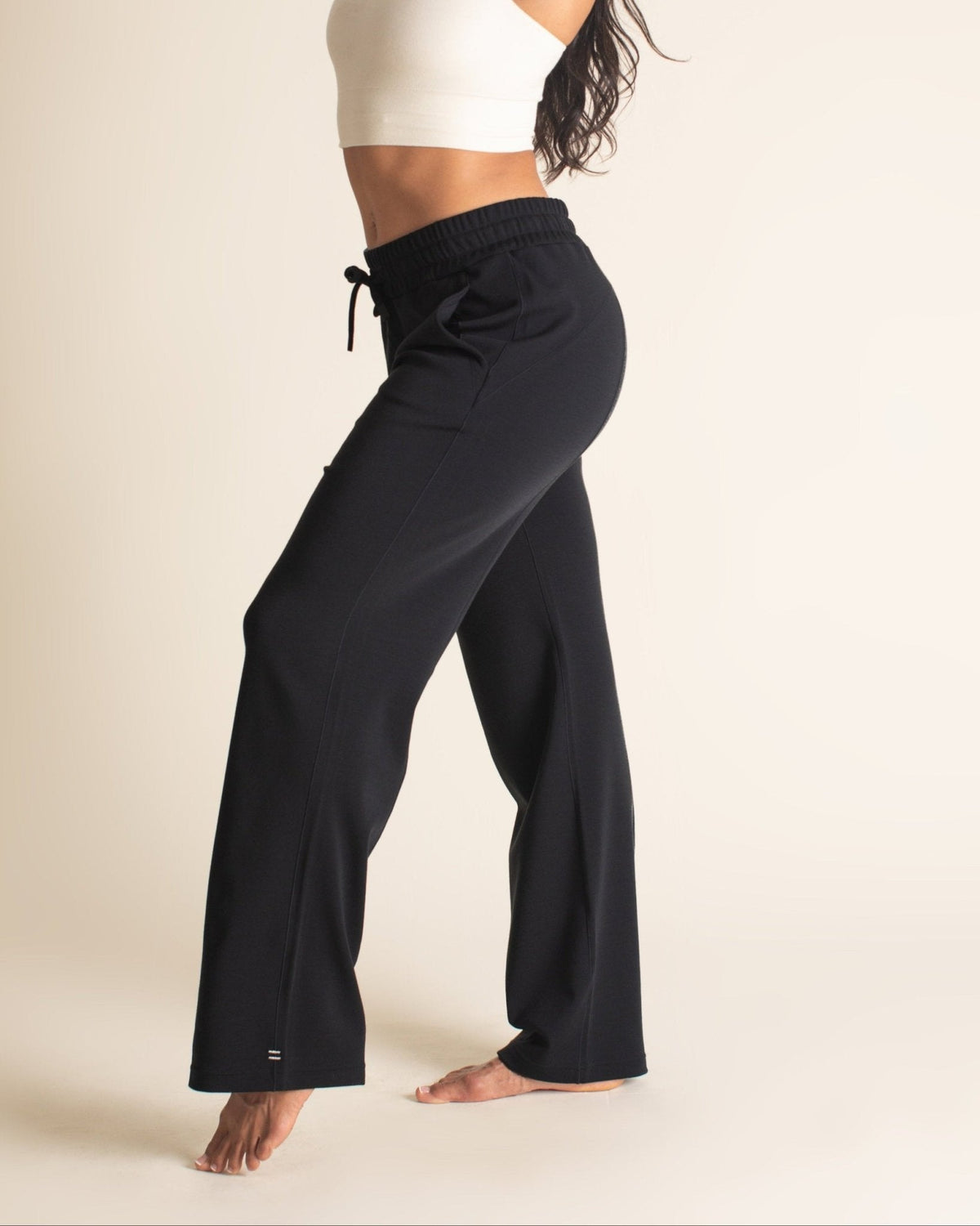 Photo of Zoe McGrady is wearing a BRANWYN women's Merino wool classic wide-legged pant, size medium, in black.