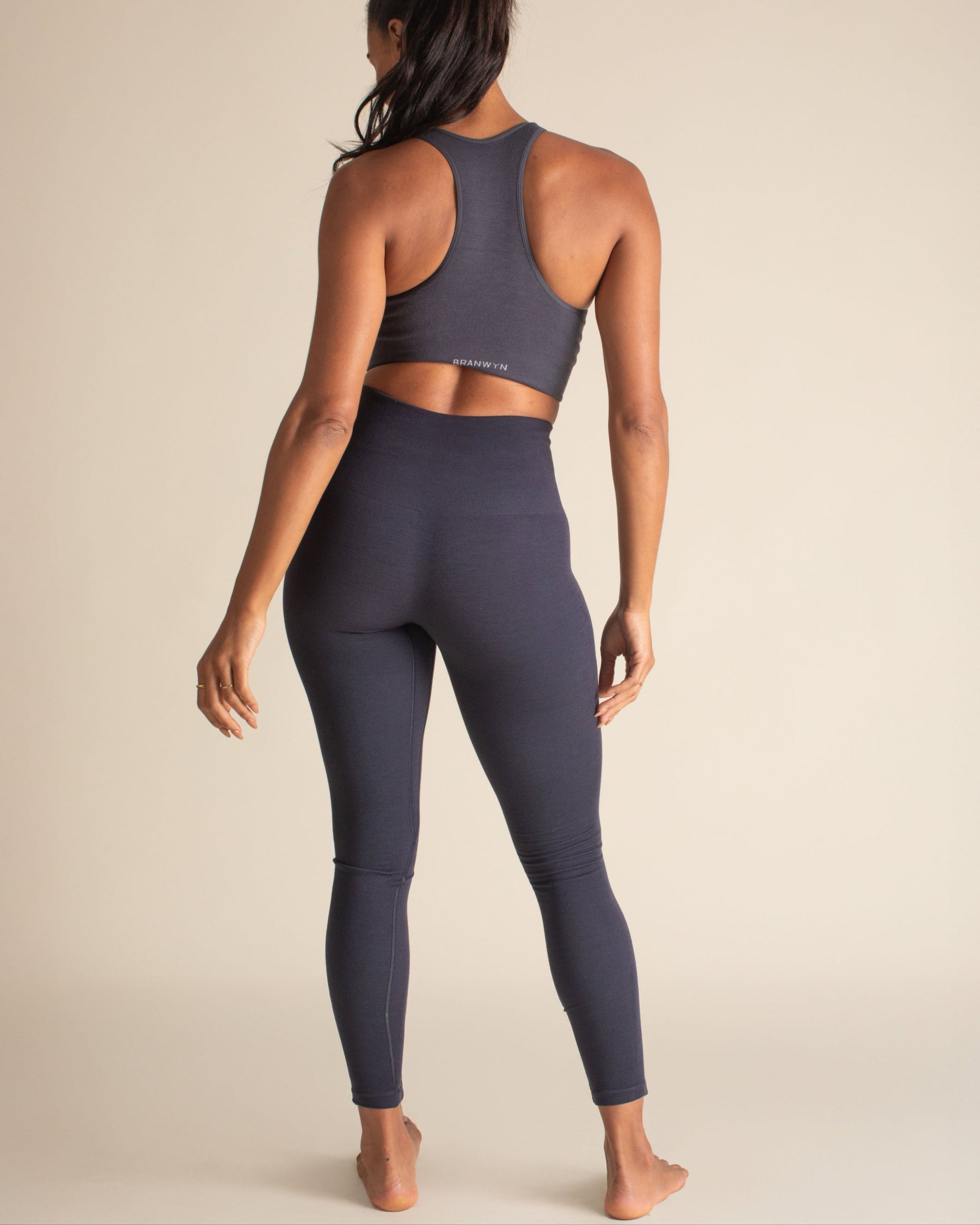 Back view of woman in Night Sky blue Merino Wool leggings, body-scuplting and temperature-regulating baselayers for winter.
