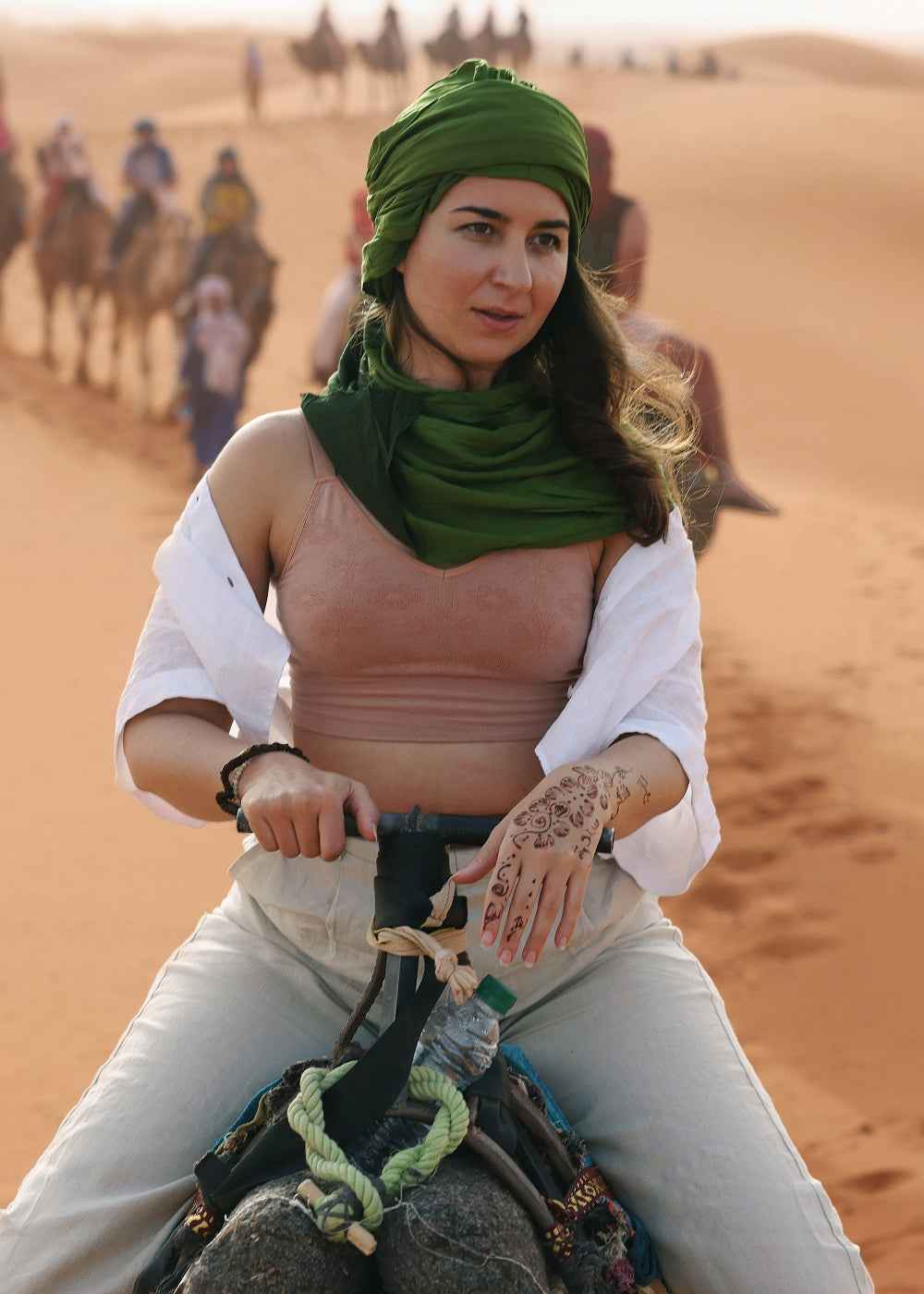 Woman traveling solo in Morocco. She is riding a camel wearing BRANWYN Merino wool bras and underwear