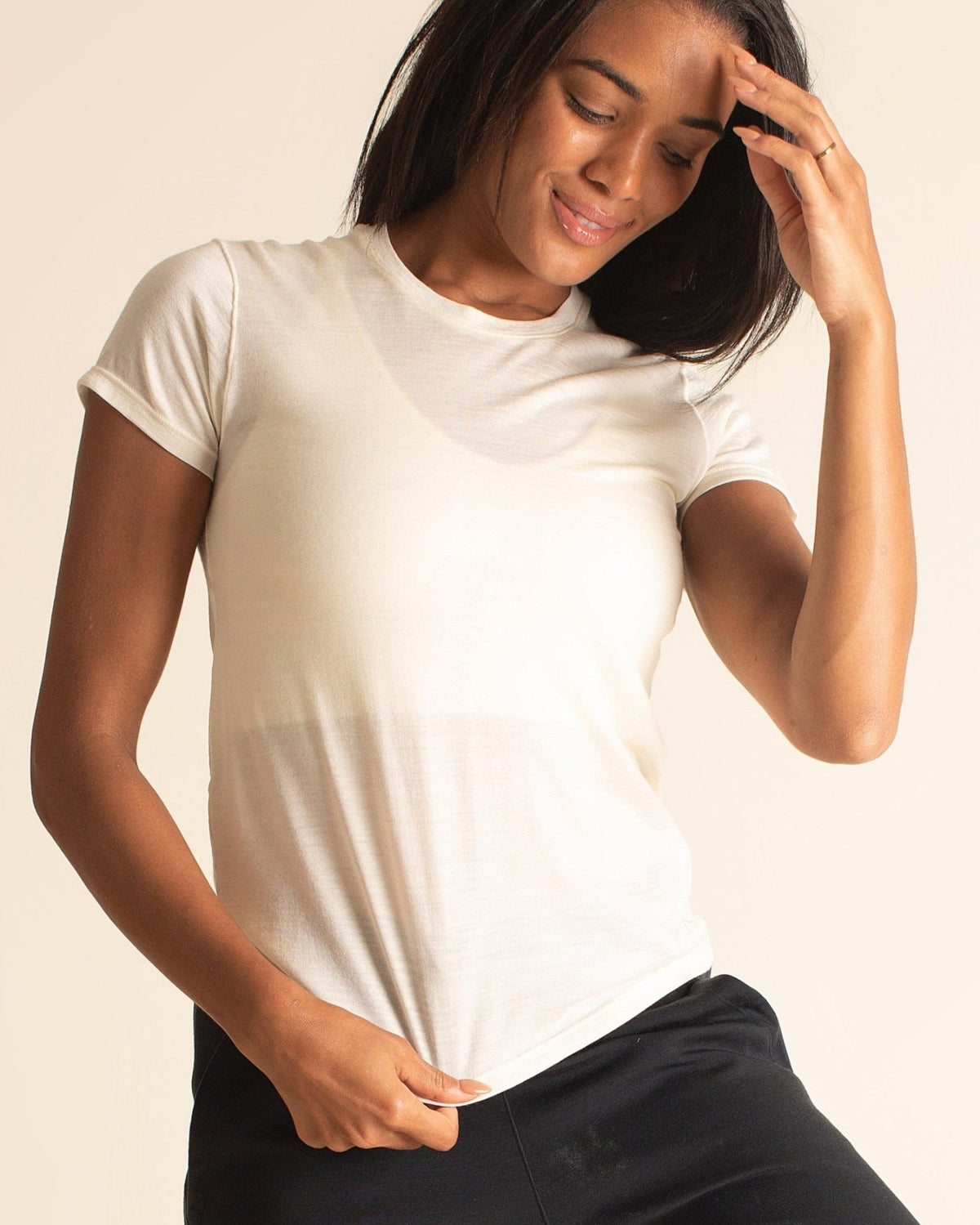 Woman wearing white BRANWYN Merino t-shirt and everyday Merino short sleeve wool top designed for comfort and breathability.