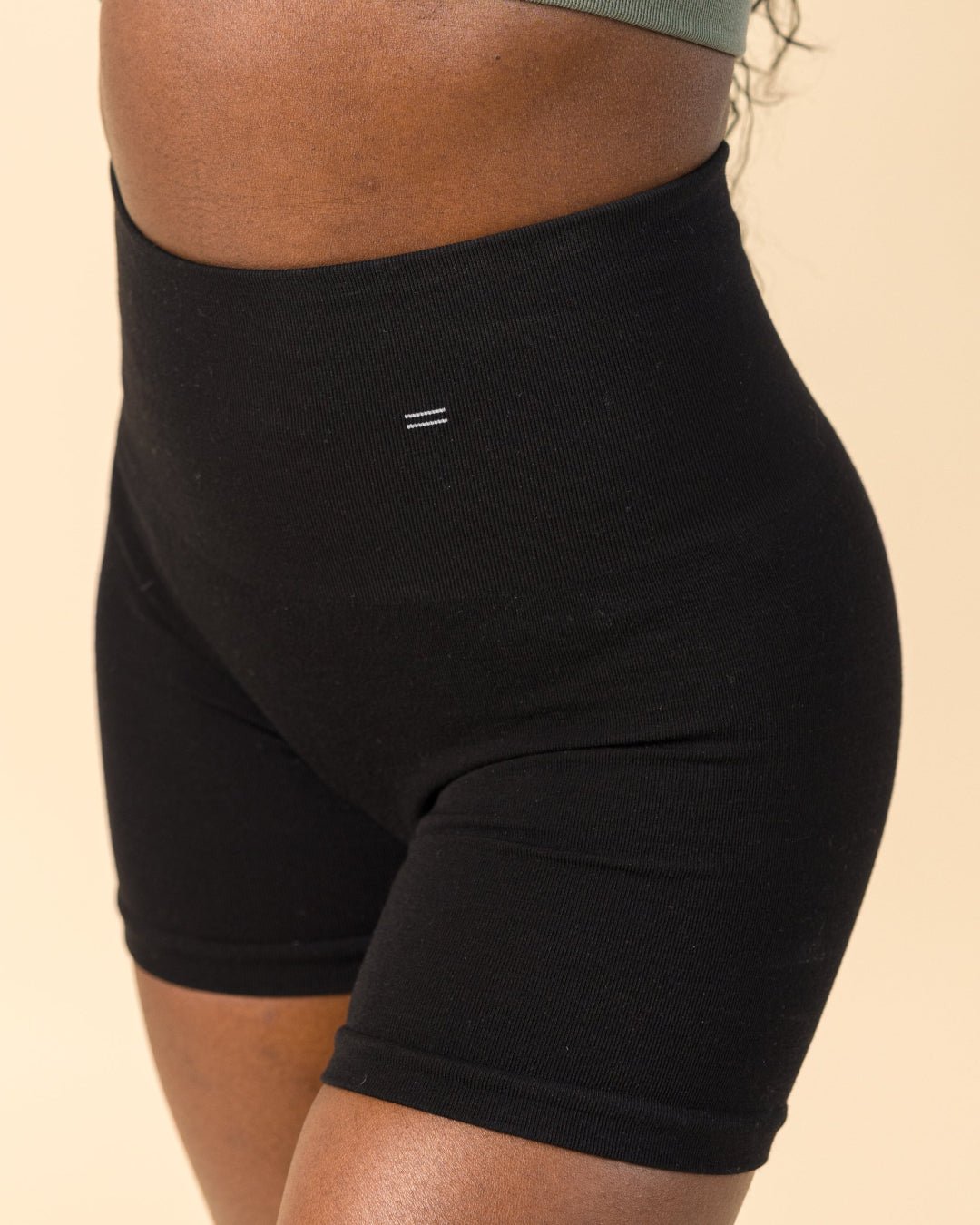 Models wears BRANWYN's seamless compressive shorts, a black Merino Wool bike short with a 6 inch inseam. Great for hiking, yoga, and the gym.