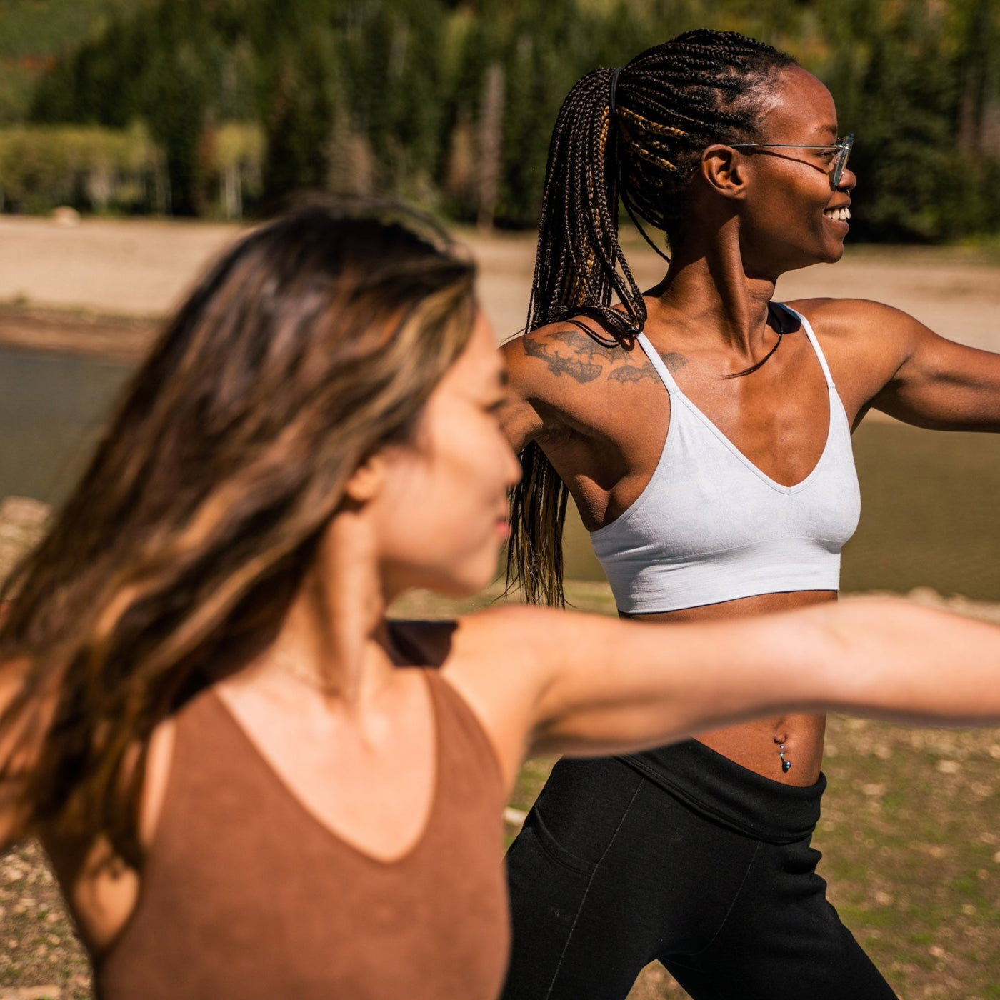 Two women doing yoga in the mountains wearing BRANWYN performance innerwear Luna Gray Bralette