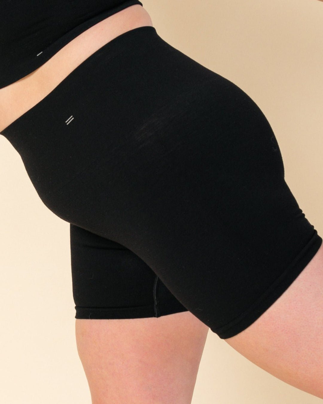 Stretching in Merino wool biker short, the BRANWYN Essential Compressive Short.