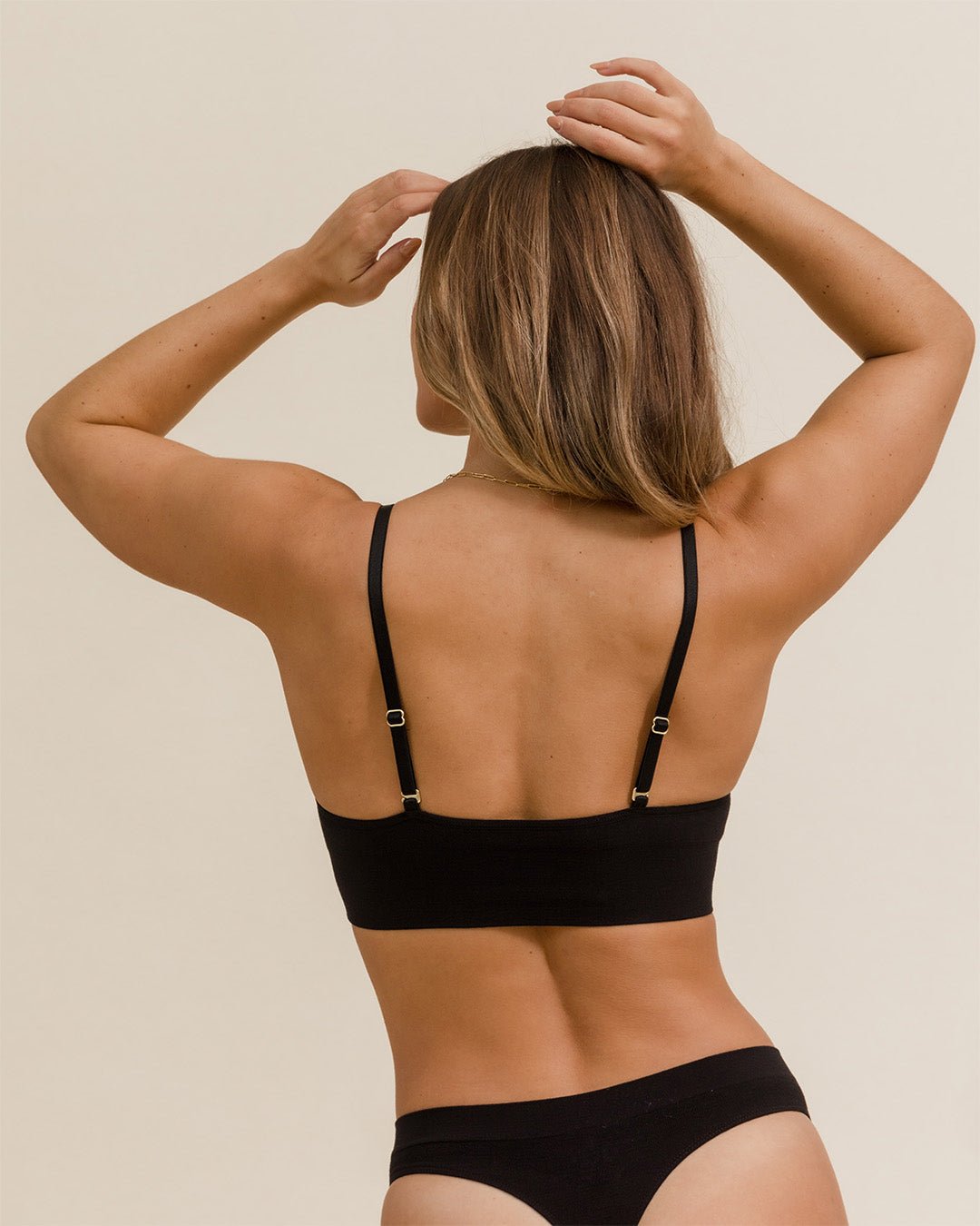 Back view of woman in BRANWYN Merino underwear set, seamless natural fiber bra and thong.