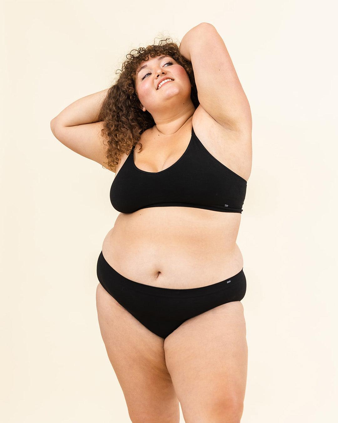 Woman standing in BRANWYN Essential Merino bralette and underwear set, seamless natural fiber innerwear.