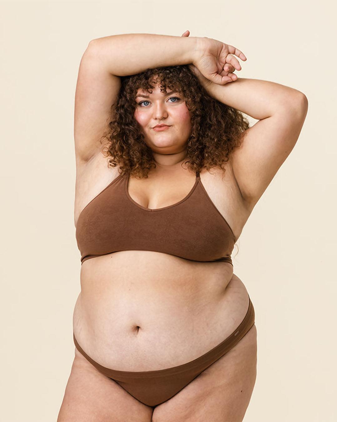 Woman in BRANWYN Essential Bralette and Merino underwear set in Dark Nude, seamless natural fiber innerwear.