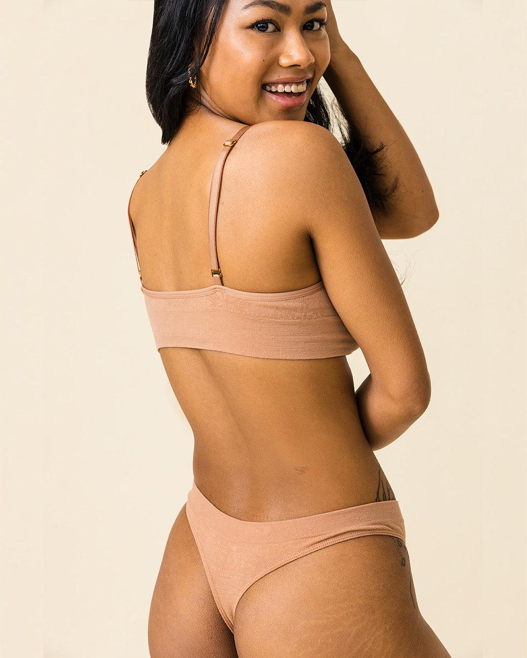 Woman in BRANWYN Warm Nude Essential Bralette and thong set, breathable sweat-wicking Merino innerwear