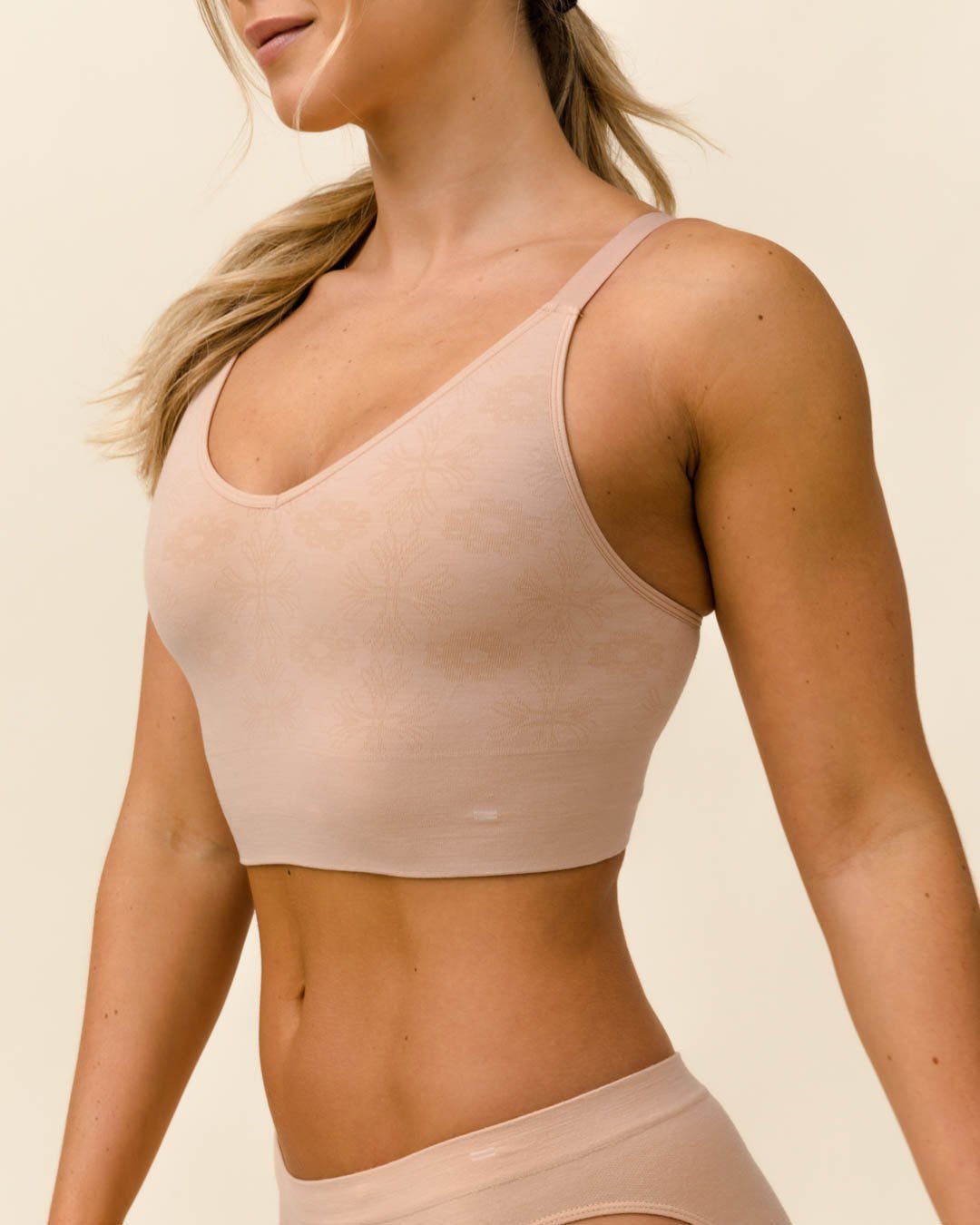 Side view of BRANWYN Busty Bra in Light Nude, seamless wireless merino bra for performance and comfort.