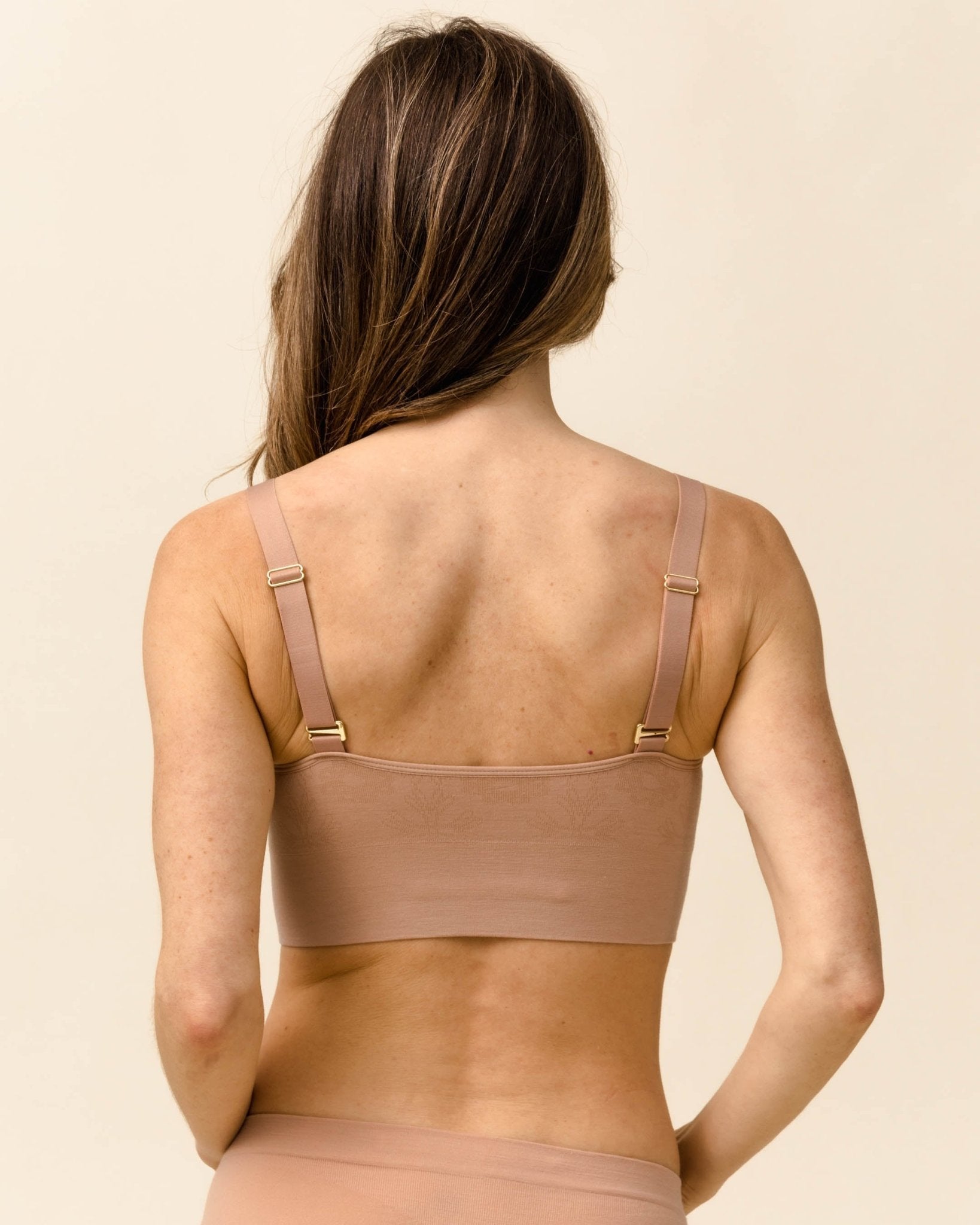 Back angle of BRANWYN Essential Busty Bra in Light Nude, seamless merino bralette for active women.