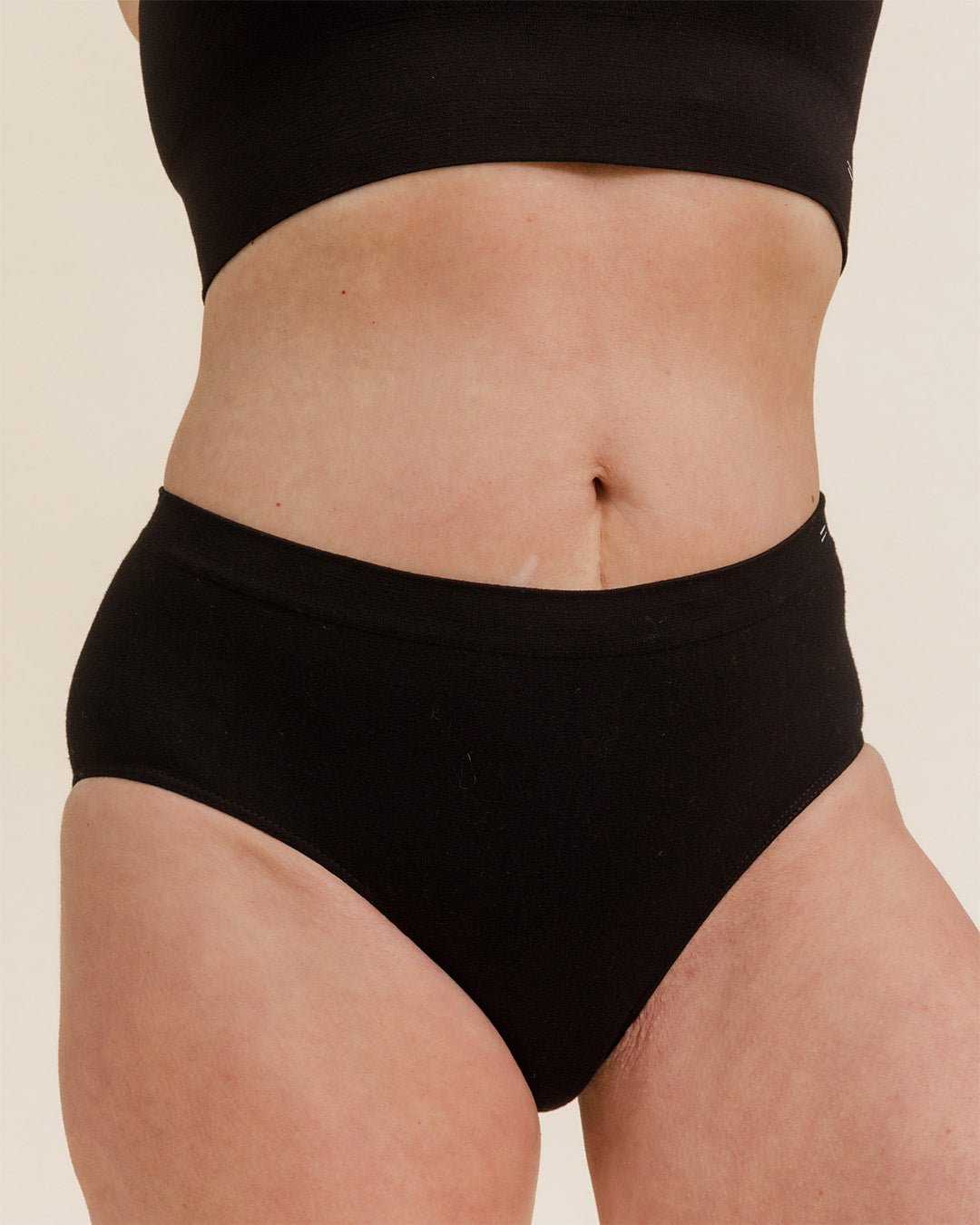Front view of woman in BRANWYN's Essential Hipster in black, soft Merino wool underwear briefs for women designed for comfort and movement.