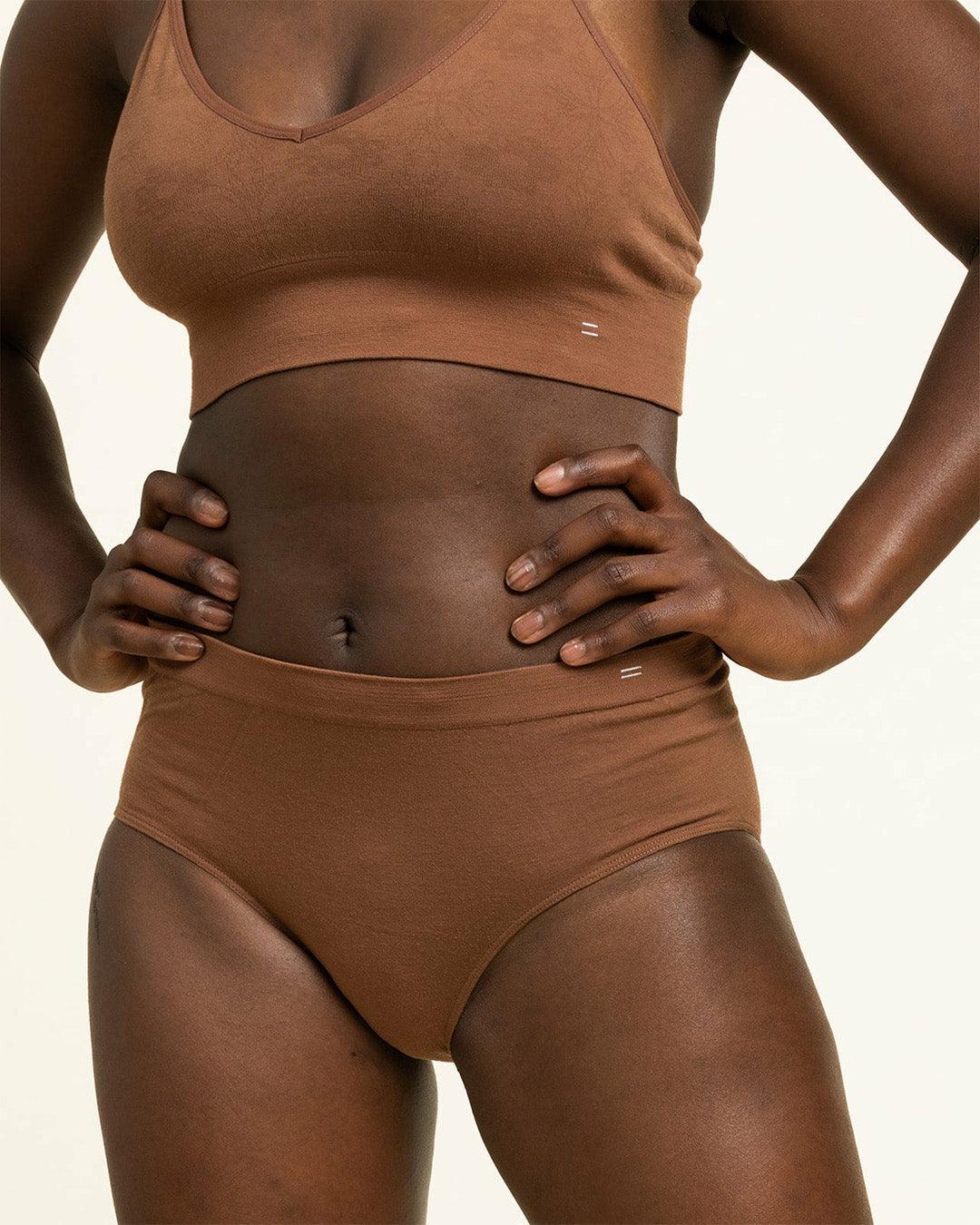Front view of woman in BRANWYN's Essential Hipster in dark nude brown. These Merino panties are sweat wicking and great for hiking, yoga, and everyday wear.