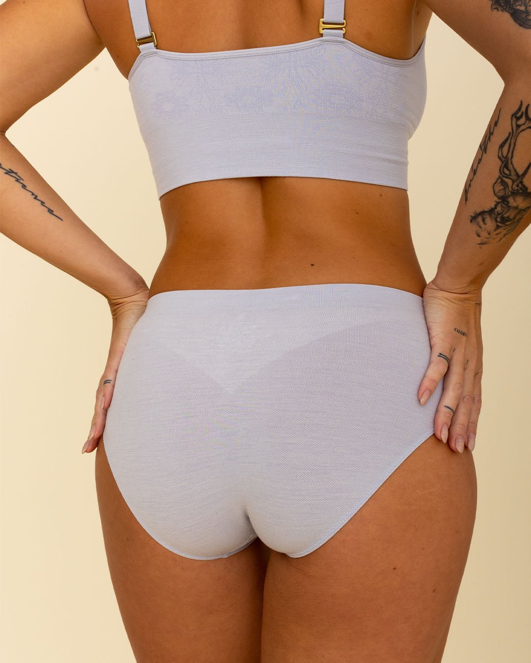 Back view of woman in high waisted, full coverage Merino Hipster style underwear from BRANWYN in Luna grey.