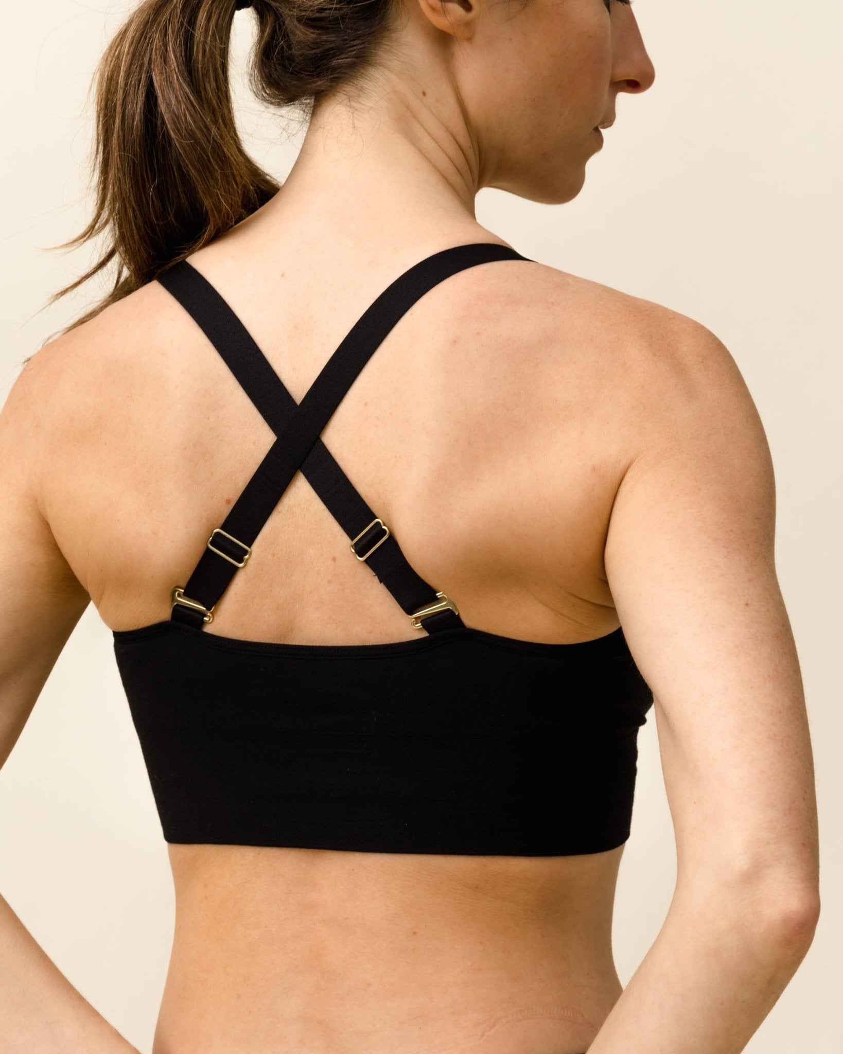 Back view of Black Essential Busty Bra by BRANWYN with adjustable criss-cross straps for added bust support.