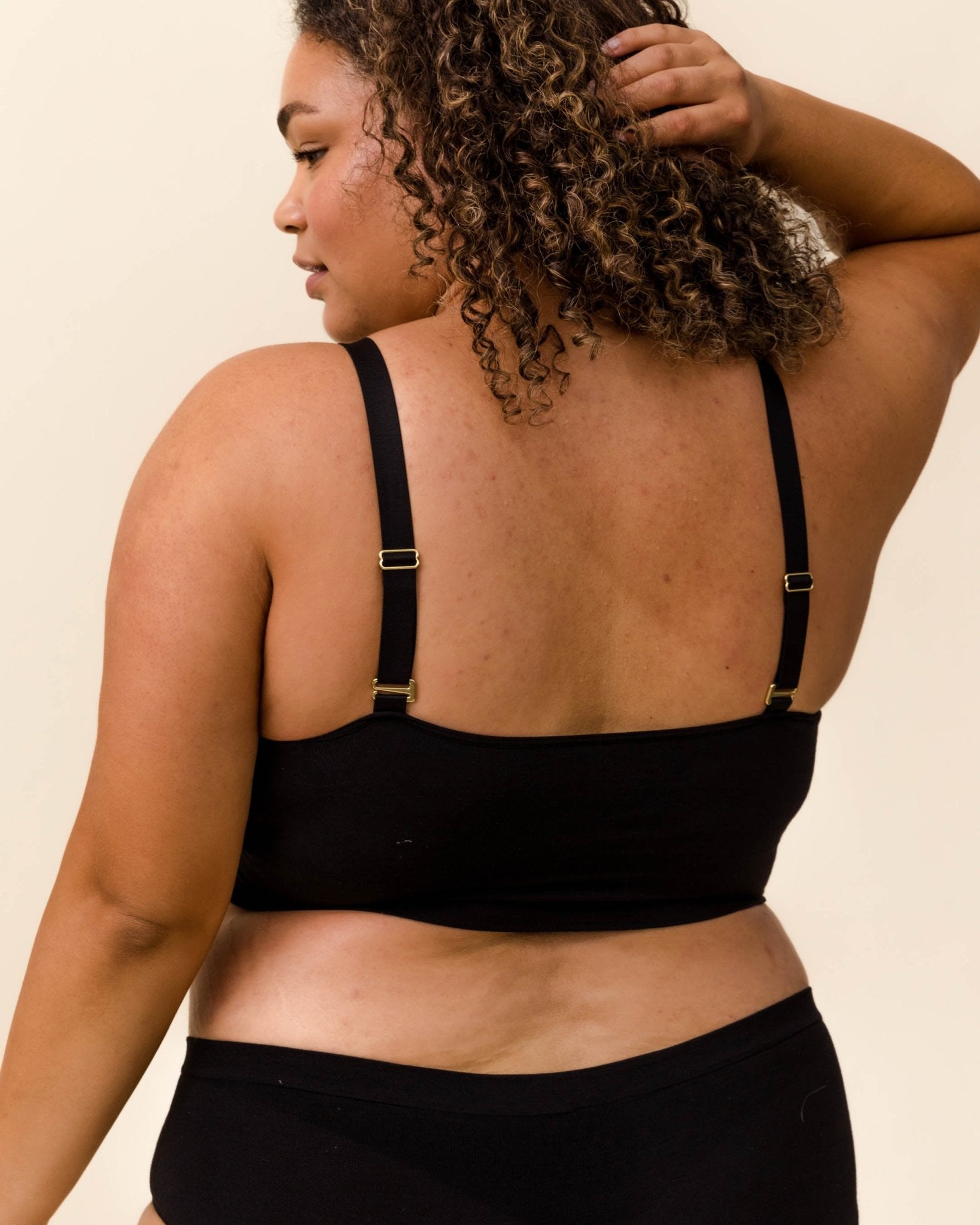 Adjustable strap detail on BRANWYN Busty Bra in black, Merino comfort with wire-free support.