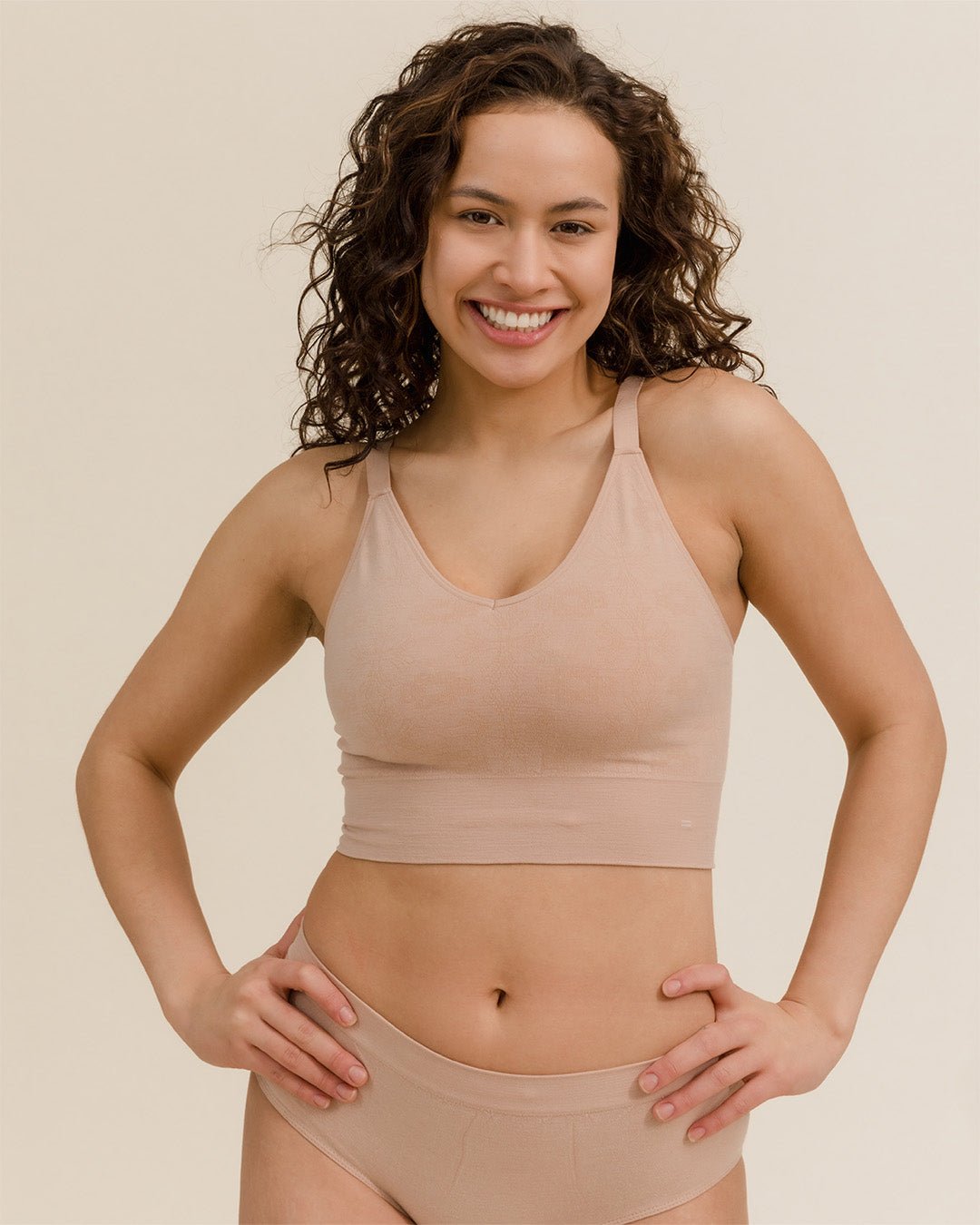 Woman in BRANWYN sustainable Merino bra and underwear set, Light Nude colorway.