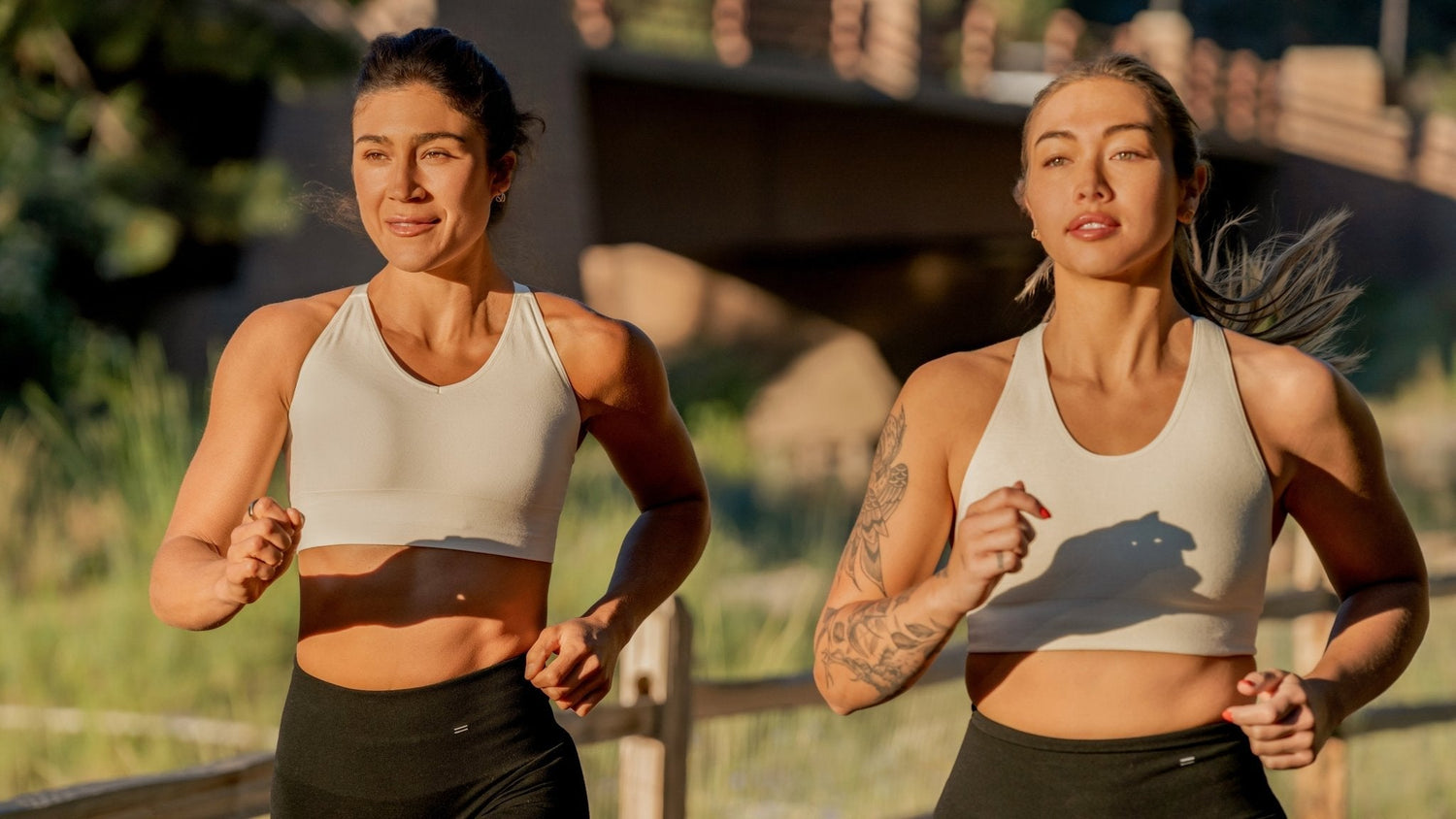 Two women running in Merino wool activewear sets.