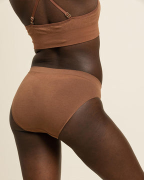Back view of the best travel underwear. BRANWYN's Essential bikini in dark nude is perfect for on the go with odor reducing and mositure wicking Merino wool.