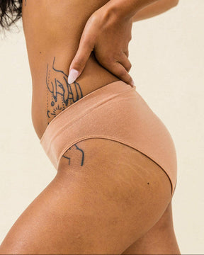 Side view of BRANWYN Essential Bikini Merino underwear in warm nude. Soft, breathable, and odor resistant, sustainable underwear.