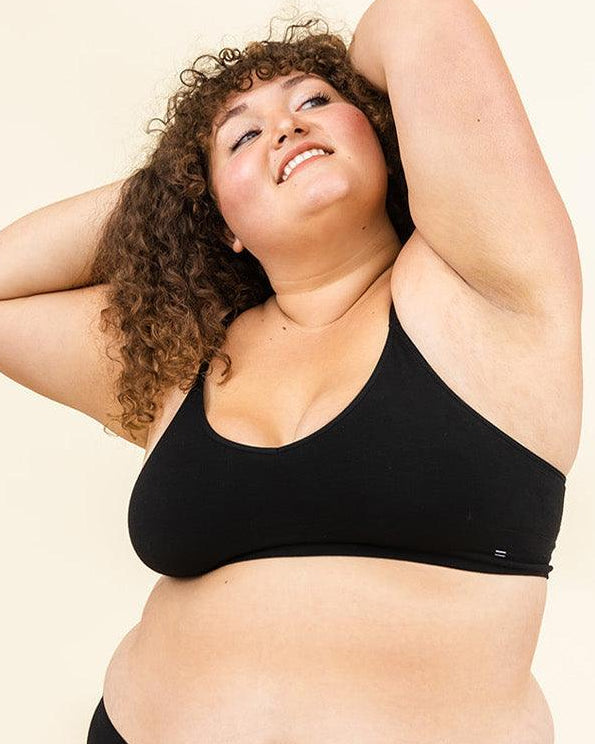 Woman standing in BRANWYN Essential Merino bralette and underwear set, seamless natural fiber innerwear.