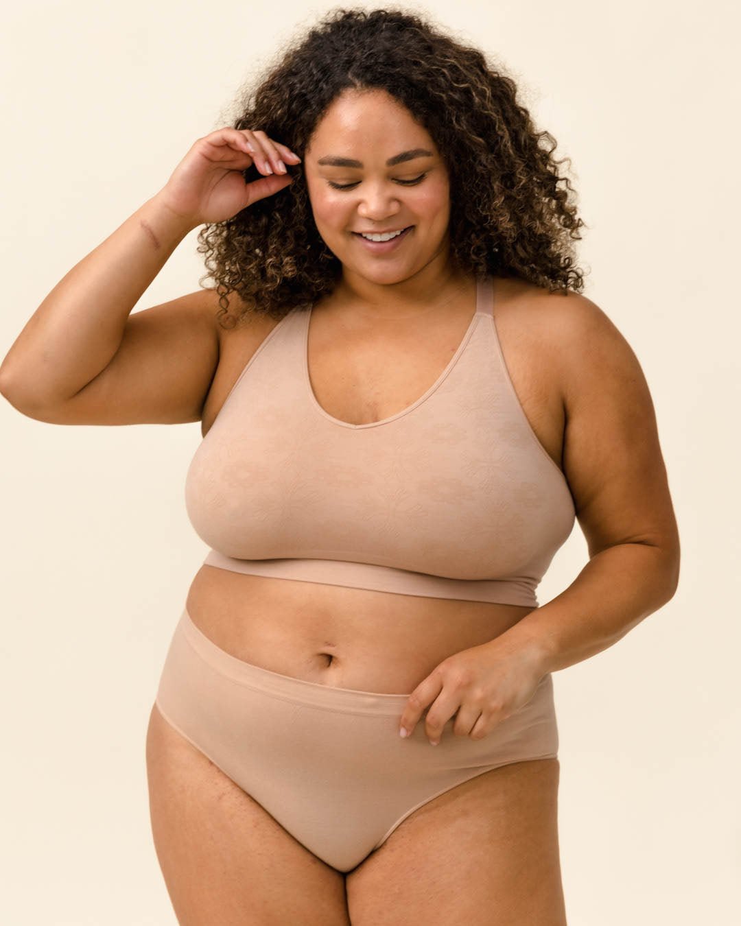 Woman smiling in Merino underwear and bra set. Wearing the Essential Hipster, BRANWYN underwear made of sustainable Merino wool natural fibers.