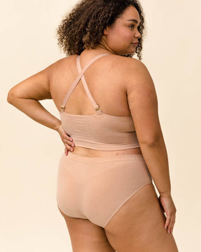 Back view of woman wearing BRANWYN Essential Hipster in light nude with matching bra. Sustainable, breathable Merino underwear for women.