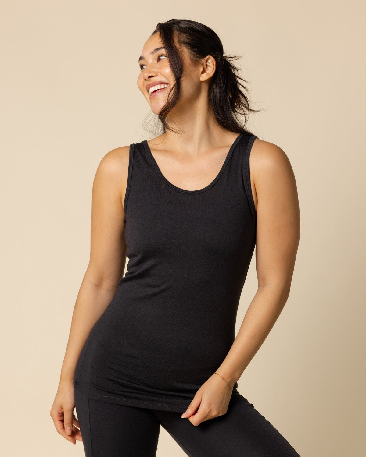 Woman wearing BRANWYN's SWAG 24 | Classic Tank, a piece from the limited-edition SWAG (Sustainable Wool Athleisure Gear) Collection. Made from ethically sourced, ultra-fine Merino wool, this piece is buttery soft, breathable, and designed for both performance and everyday wear.