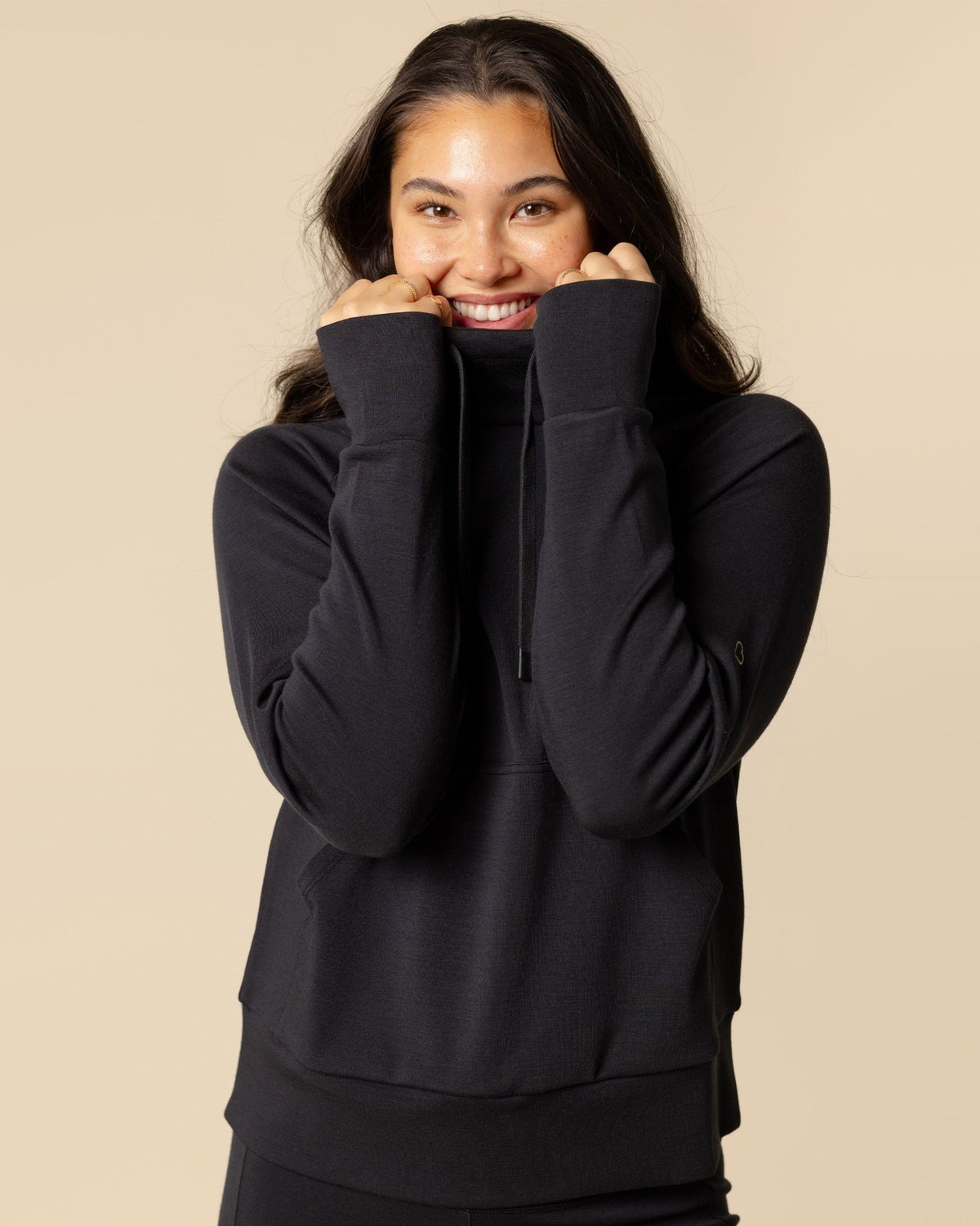 Woman wearing BRANWYN's SWAG 24 | Hoodie Pullover, a piece from the limited-edition SWAG (Sustainable Wool Athleisure Gear) Collection. Made from ethically sourced, ultra-fine Merino wool, this piece is buttery soft, breathable, and designed for both performance and everyday wear.