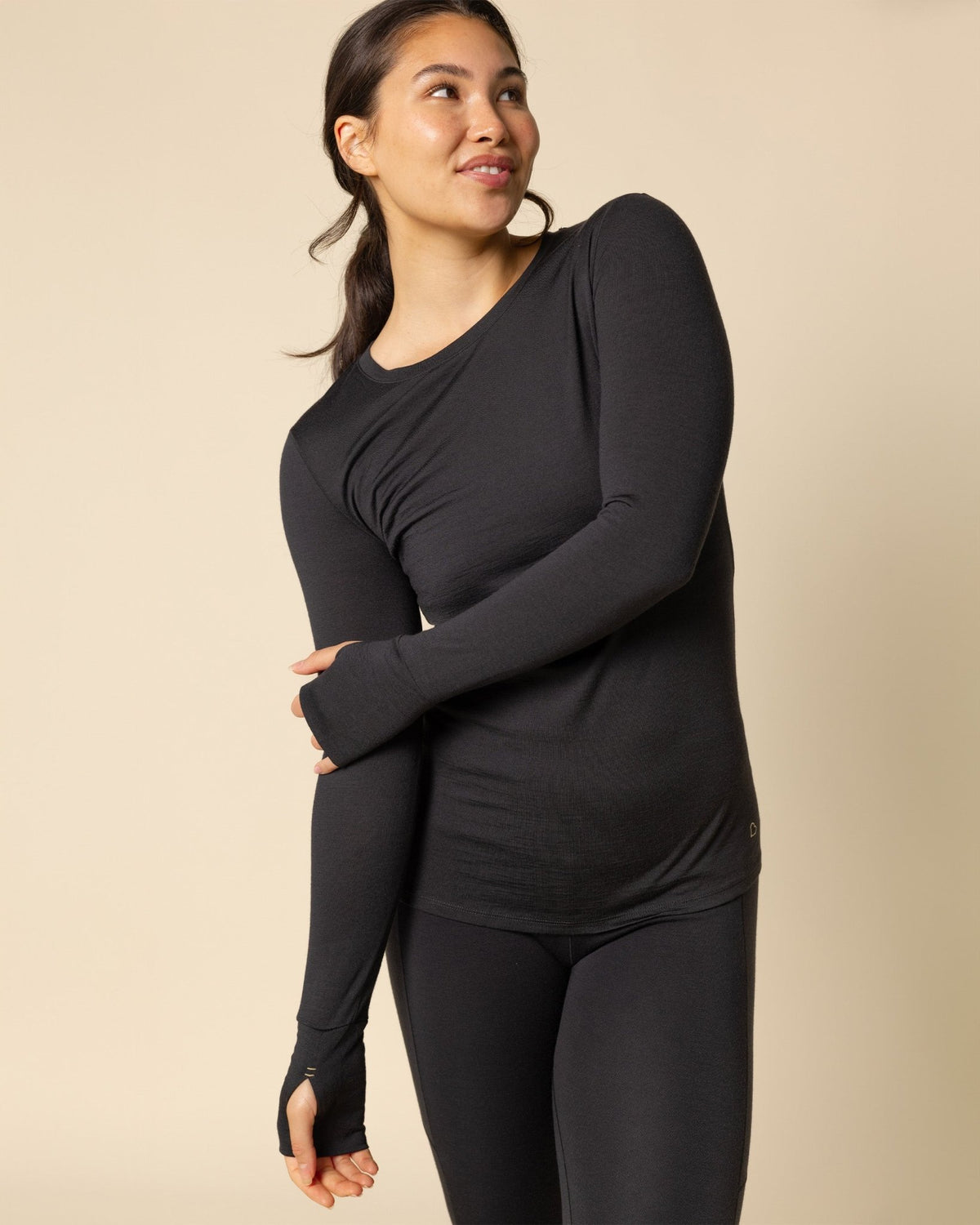 Woman wearing BRANWYN's SWAG 24 | Long Sleeve Tee, a piece from the limited-edition SWAG (Sustainable Wool Athleisure Gear) Collection. Made from ethically sourced, ultra-fine Merino wool, this piece is buttery soft, breathable, and designed for both performance and everyday wear.