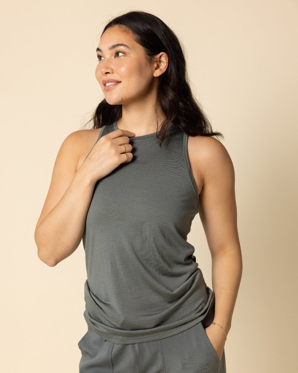 Woman wearing BRANWYN's SWAG 24 | Racerback Tank, a piece from the limited-edition SWAG (Sustainable Wool Athleisure Gear) Collection. Made from ethically sourced, ultra-fine Merino wool, this piece is buttery soft, breathable, and designed for both performance and everyday wear.