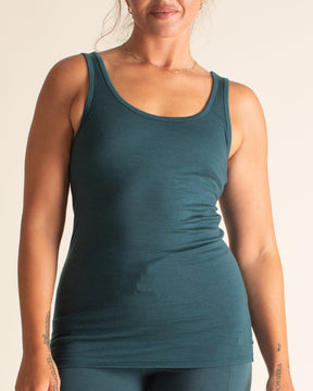 Woman wearing a BRANWYN Women's Merino Wool Teal Tank and Black Merino Wool High-waist joggers and leggings Teal