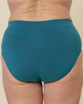 Back view of a model wearing BRANWYN Sustainable Seamless Merino Wool Essential Hipster in Transformative Teal.