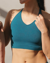 Front view of a model wearing BRANWYN natural fiber and plastic-free Seamless Merino Wool Essential Busty Bra  in Transformative Teal.