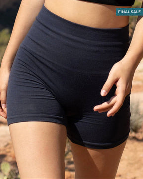 Woman in athletic wear standing in a desert landscape