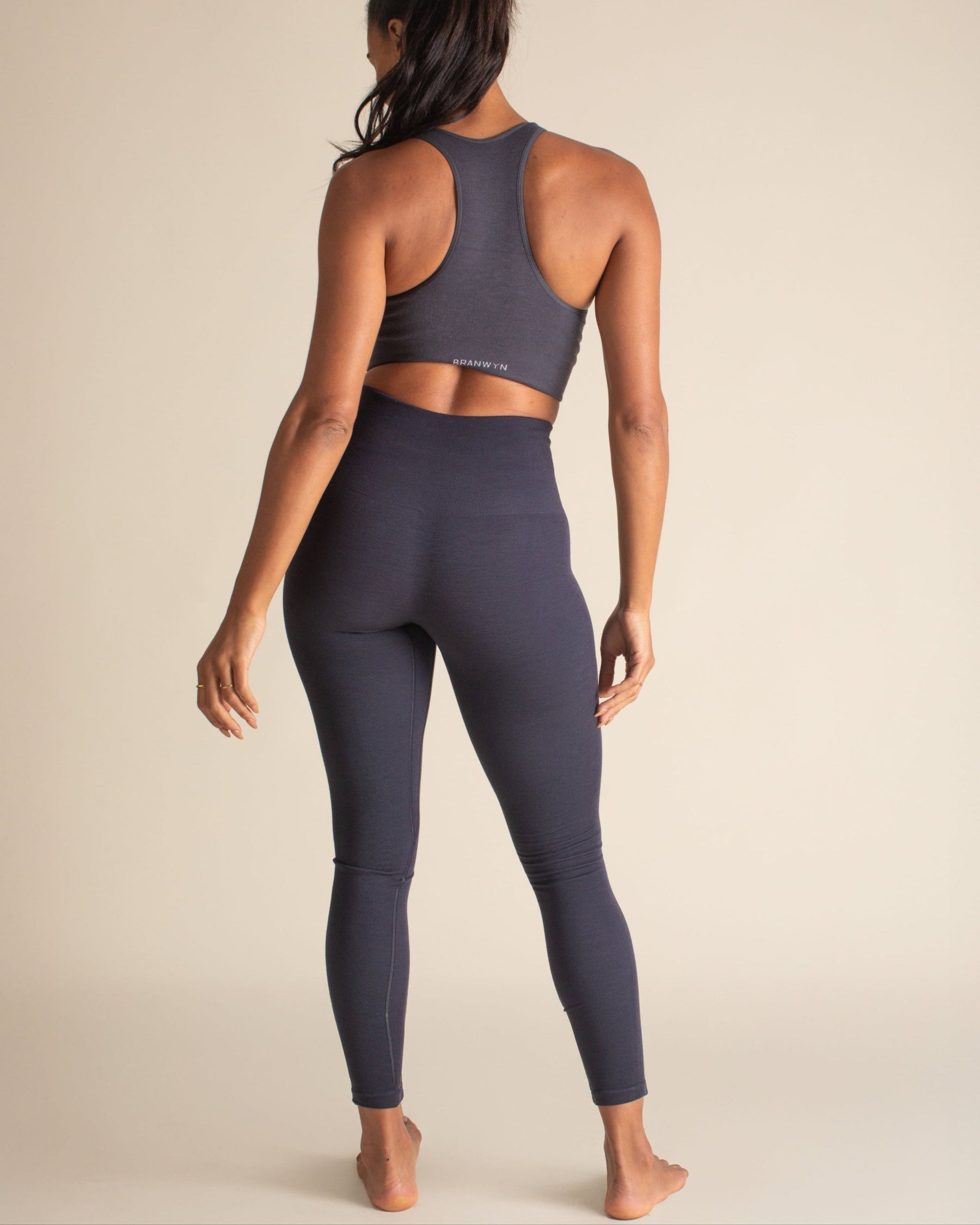 Back view of woman in Night Sky blue Merino Wool leggings, body-scuplting and temperature-regulating baselayers for winter.