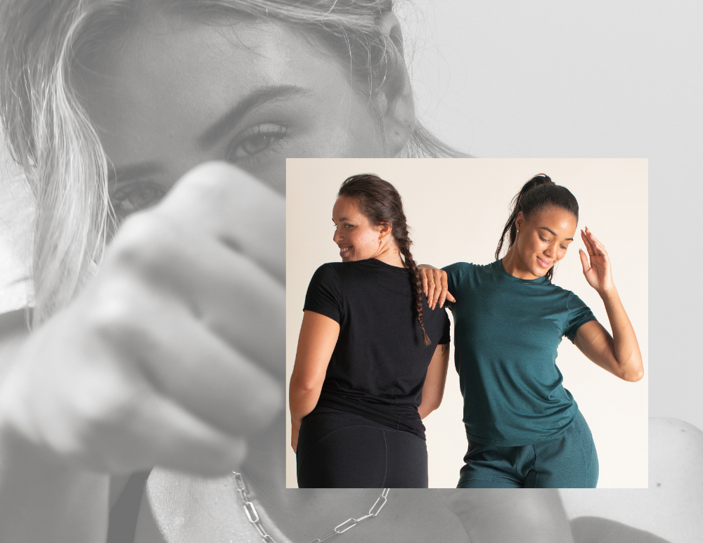 Two women wearing black and teal merino wool shirts with a blurred background