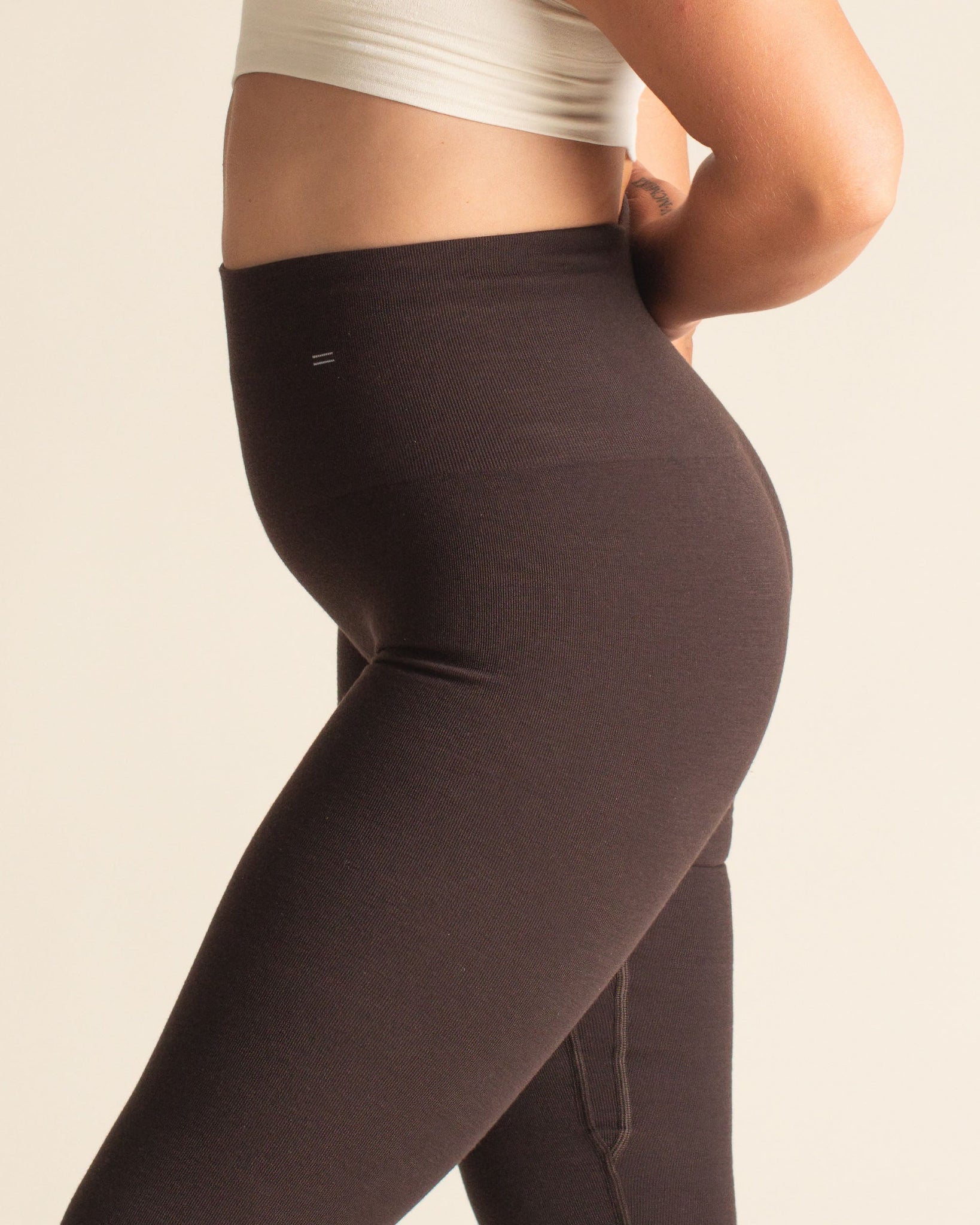 Close-up of BRANWYN Mocha Brown Merino Compression Leggings with body-sculpting fit and natural sweat-wicking wool for hot yoga or running.