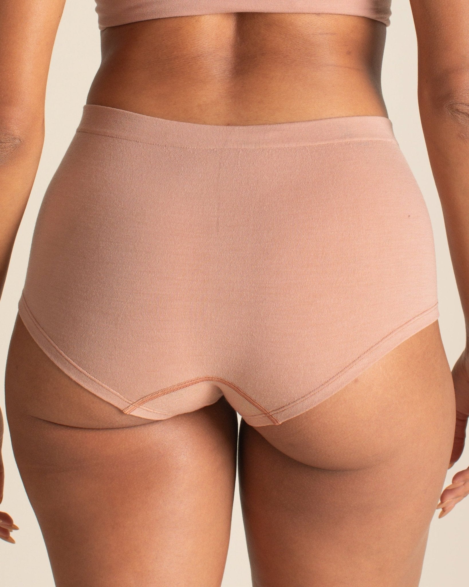 Back view of BRANWYN Essential Boyshort in warm nude. Seamless Merino wool underwear that is breathable, moisture wicking, and odor free.