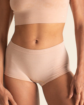 Front view of light nude seamless boyshort brief underwear by BRANWYN. This high waisted Merino wool underwear is designed to stay put and move with you through activity.