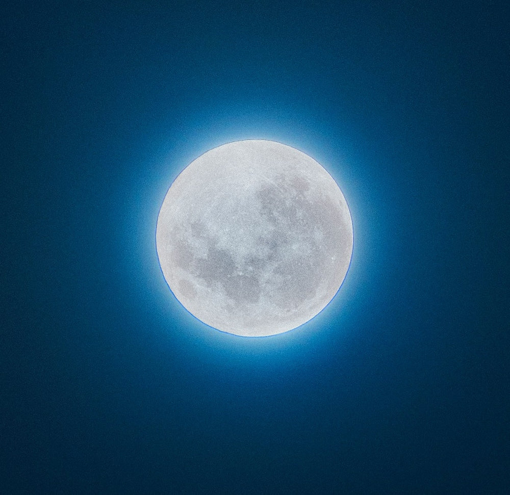Full moon against a dark blue sky
