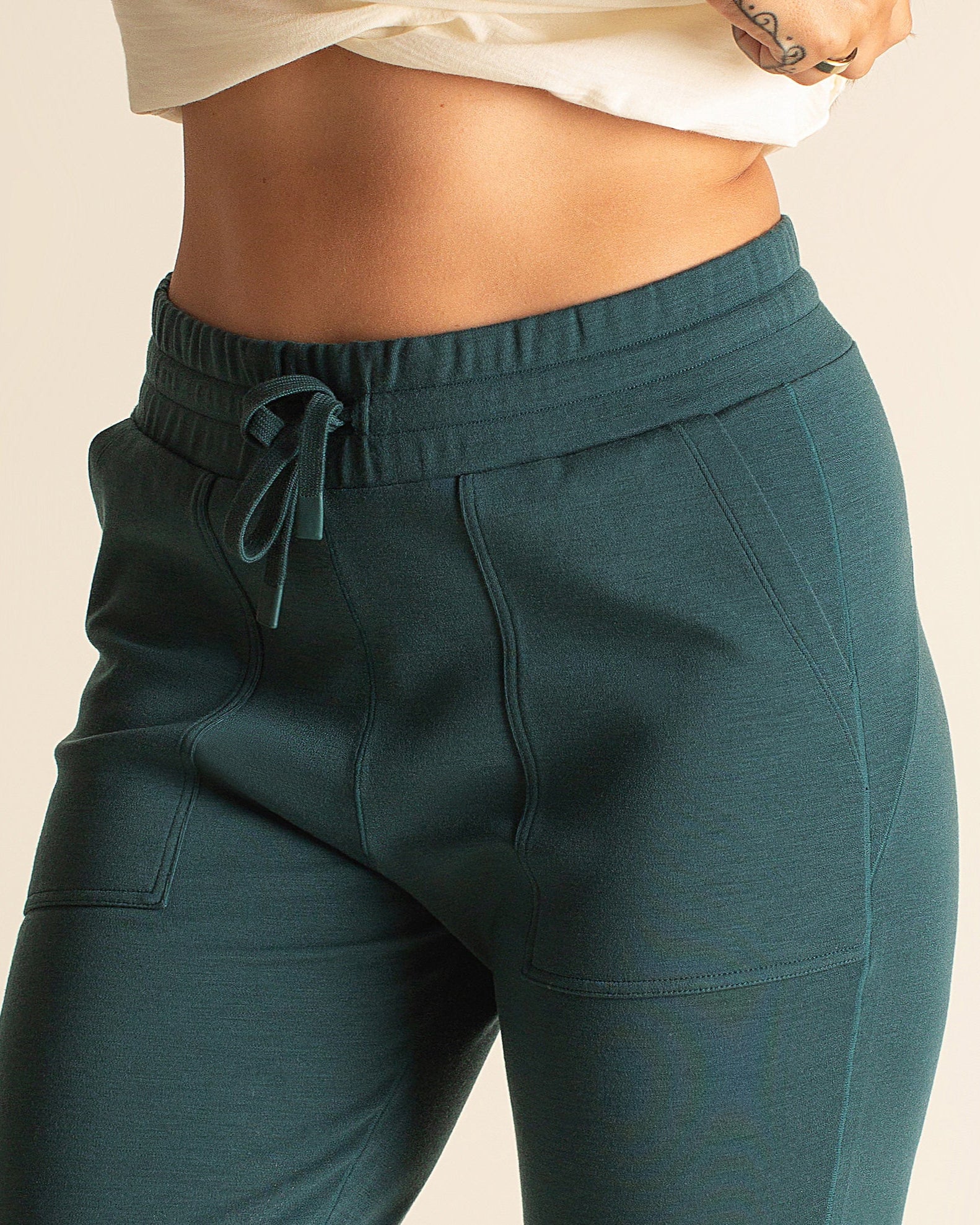 Detail view of teal BRANWYN Merino wool jogger sweatpants with drawstring waistband and pockets. Versatile sustainable joggers for travel, lounging, or active days.