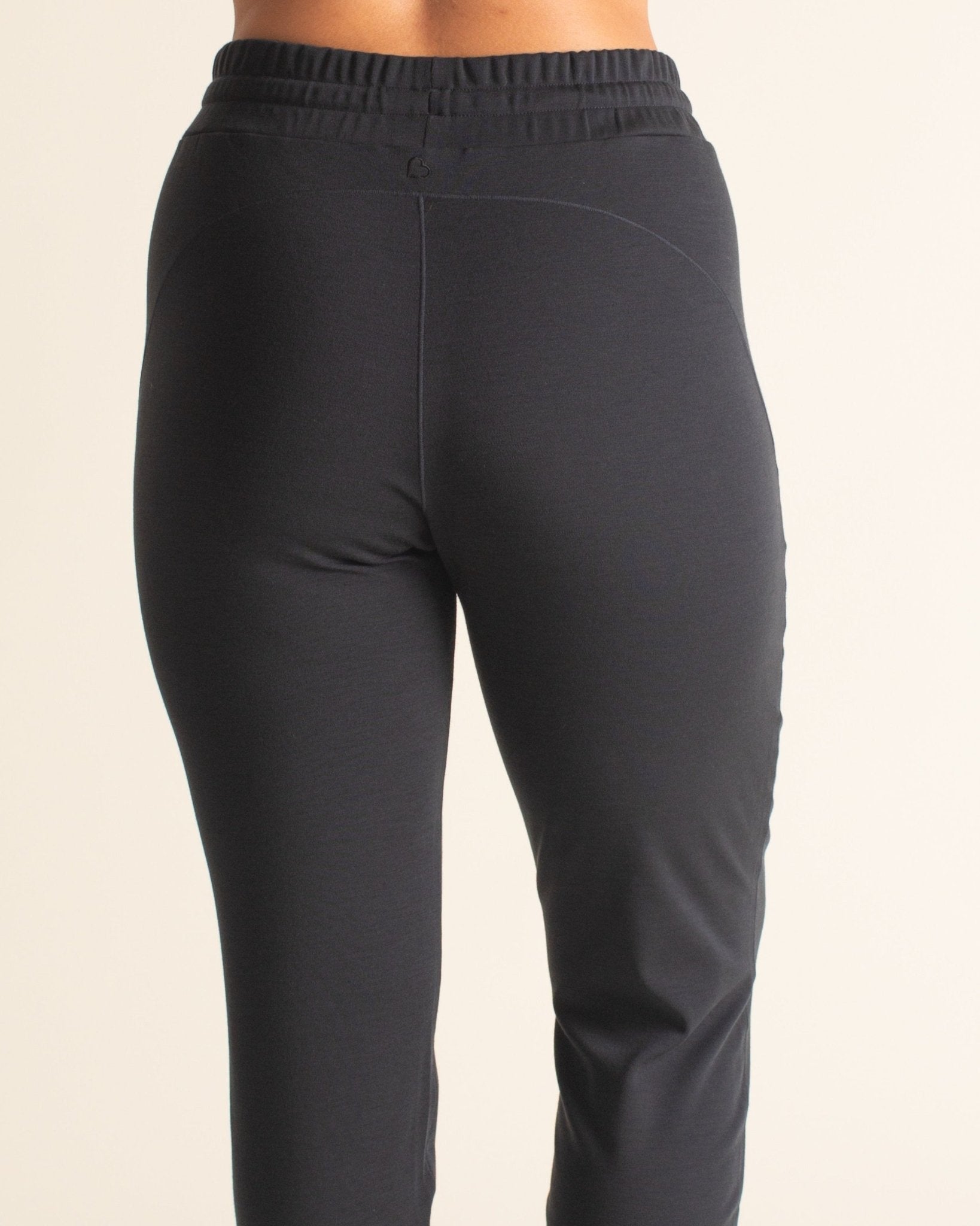 Back view of BRANWYN black Merino wool jogger sweatpants with drawstring waist. The perfect chic sweatpants for travel.