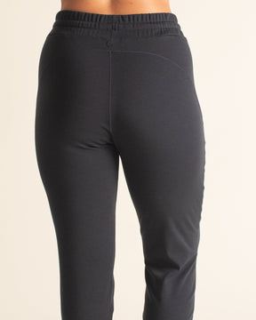 Back view of BRANWYN black Merino wool jogger sweatpants with drawstring waist. The perfect chic sweatpants for travel.