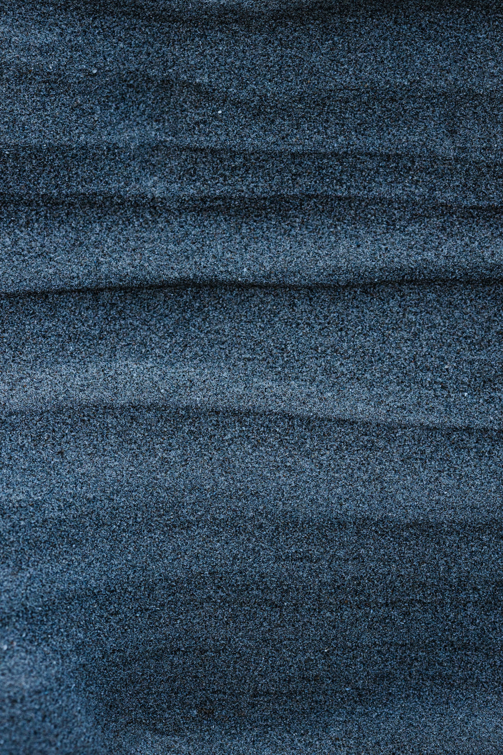 Blue-gray sand ripples in soft slate tones, color inspiration for the BRANWYN Slate collection