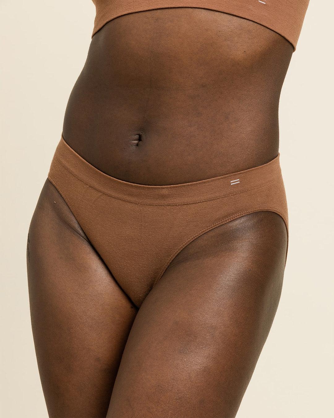 Woman wearing BRANWYN's Essential Bikini, a underwear from the Essential Collection. Made from soft, moisture-wicking Merino wool using seamless technology, this performance innerwear provides performance, comfort, and sustainability. The fabric is free from BPA, PFAS, and forever chemicals.