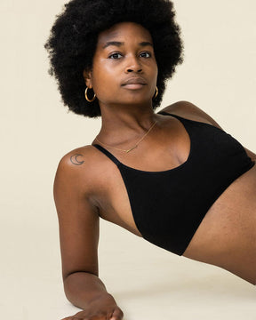 Woman wearing BRANWYN's Essential Bralette, a bra from the Essential Collection. Made from soft, moisture-wicking Merino wool using seamless technology, this performance innerwear provides performance, comfort, and sustainability. The fabric is free from BPA, PFAS, and forever chemicals.