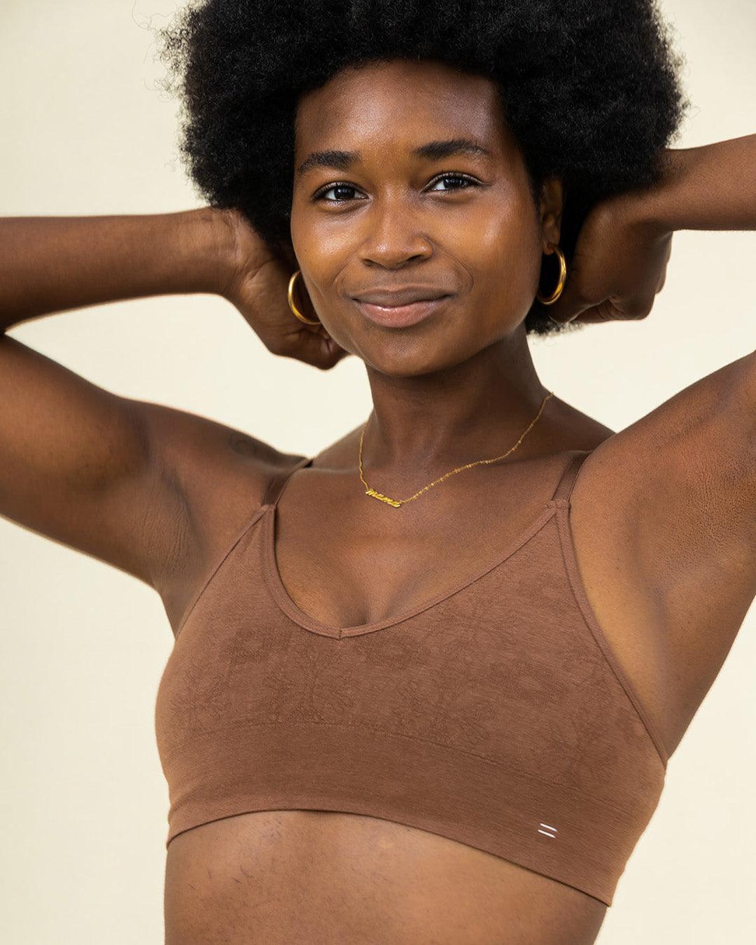 Woman wearing BRANWYN's Essential Bralette, a bra from the Essential Collection. Made from soft, moisture-wicking Merino wool using seamless technology, this performance innerwear provides performance, comfort, and sustainability. The fabric is free from BPA, PFAS, and forever chemicals.